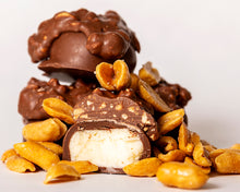 Load image into Gallery viewer, close-up shot of our famous milk chocolate peanut butter creams with peanuts
